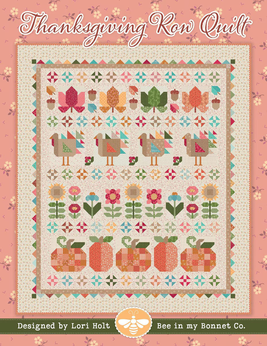 Thanksgiving-themed quilt with colorful patterns on a pink background, designed by Lori Holt for Bee in my Bonnet Co.