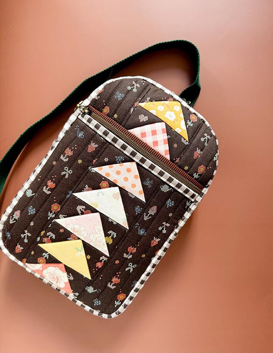 Quilted pouch with geometric pattern on a brown background