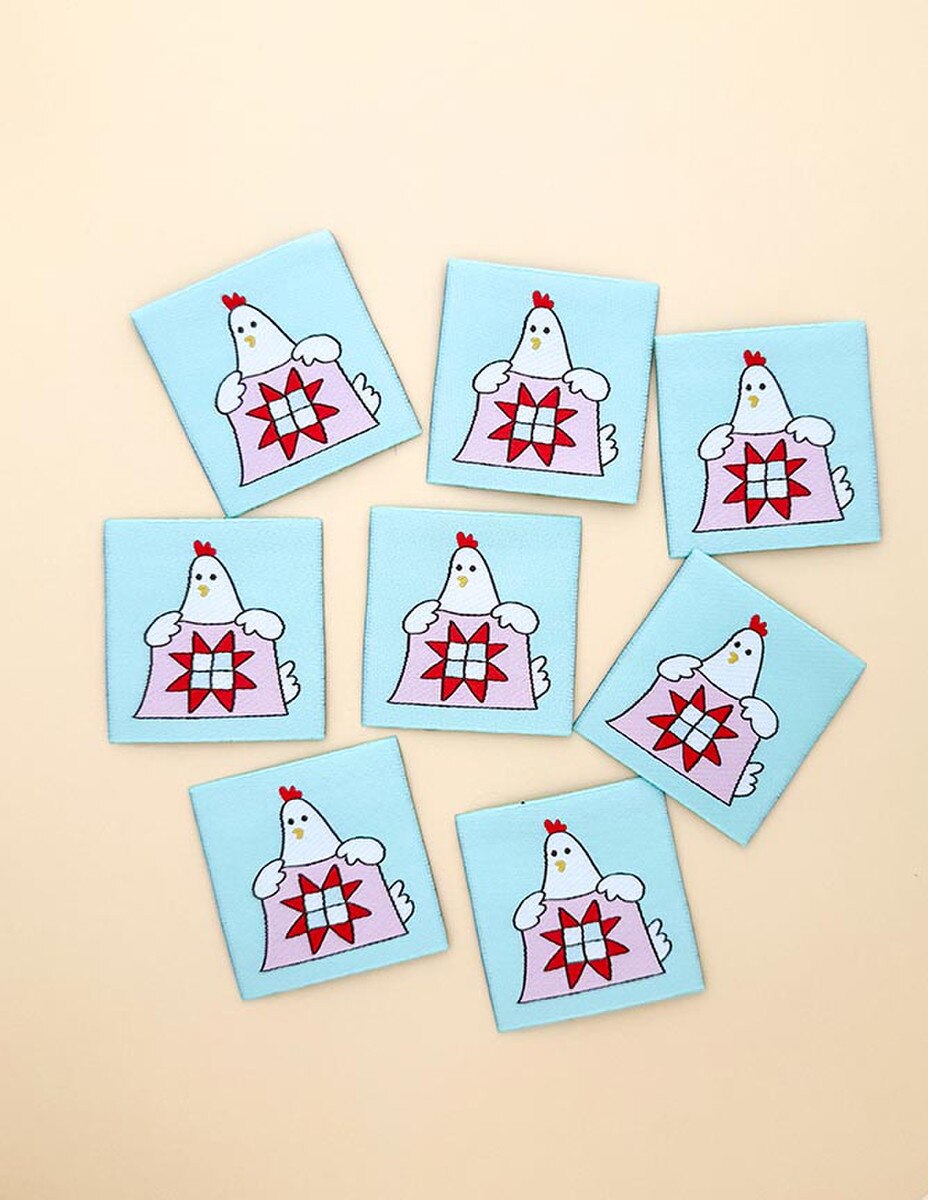 Set of eight decorative tags with chicken designs on a beige background