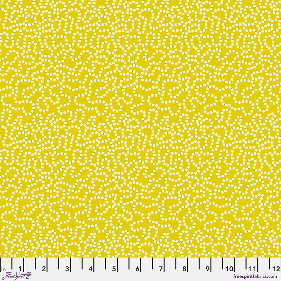 Patterned fabric with white dots on a yellow background