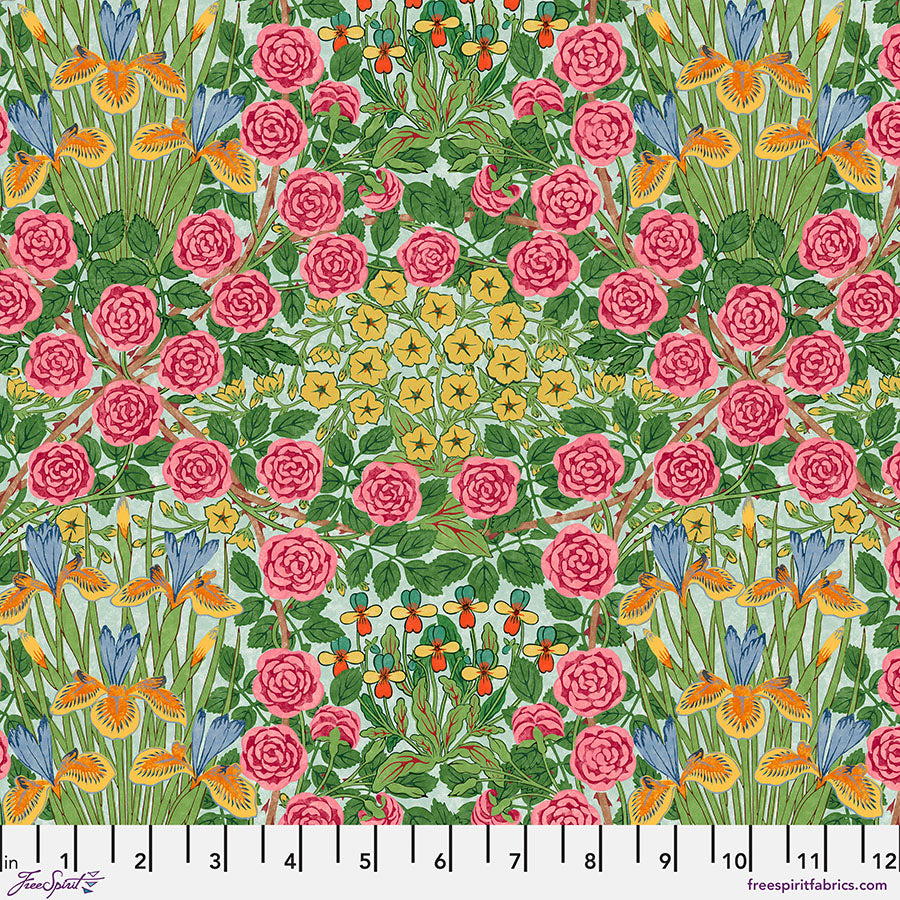 Patterned fabric with pink roses, green leaves, and blue and orange flowers, featuring a ruler at the bottom.