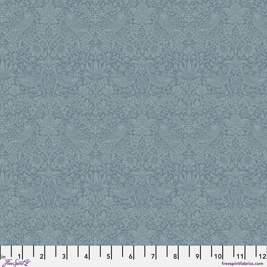 Blue fabric with a subtle pattern and a ruler at the bottom for scale.