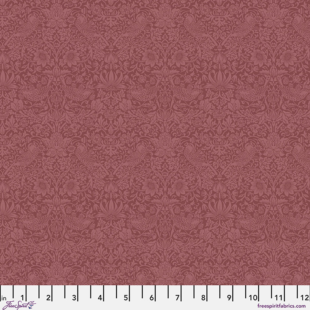 Patterned fabric swatch on a red background with a ruler at the bottom.