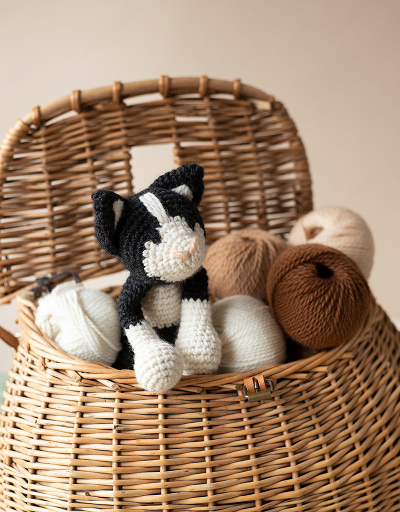 Adorable Paddy the stuffed cat in a basket of yarn