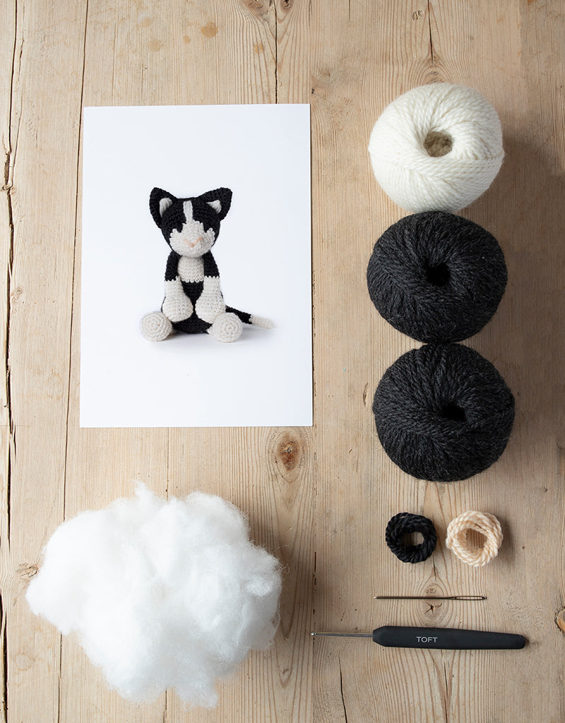 Paddy the Black and White Crochet Kit includes yarn, stuffing, needle, and crochet hook