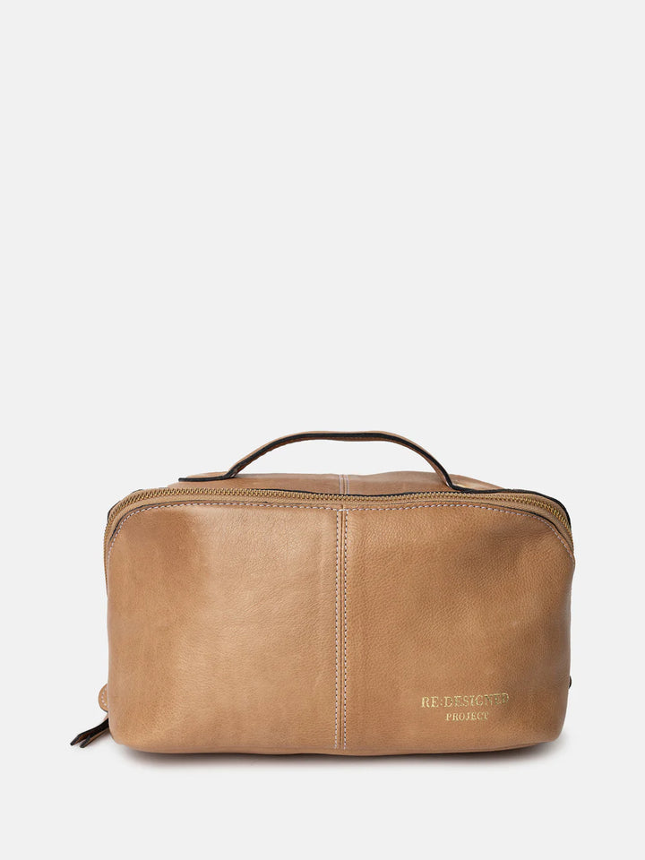 Brown leather toiletry bag with visible brand name on a white background