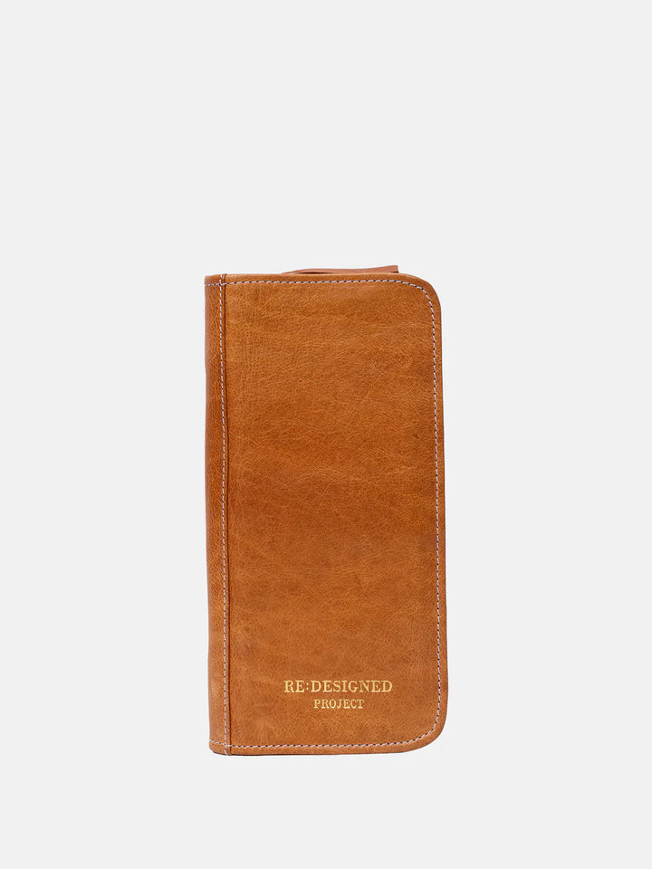 Brown leather knitting needle case with 'Re-Designed Project' branding on a white background