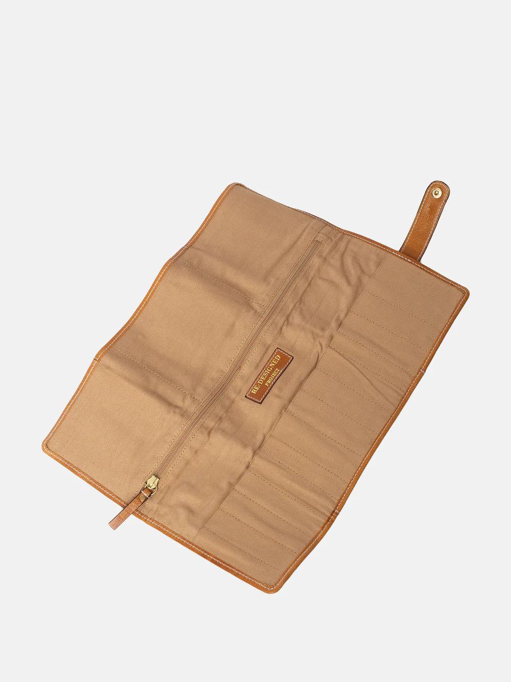 Brown leather needle case with a visible brand logo on a light gray background