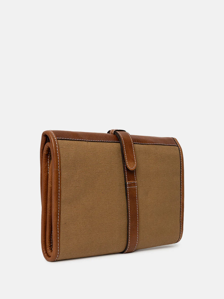 Brown leather needle case on a light beige background