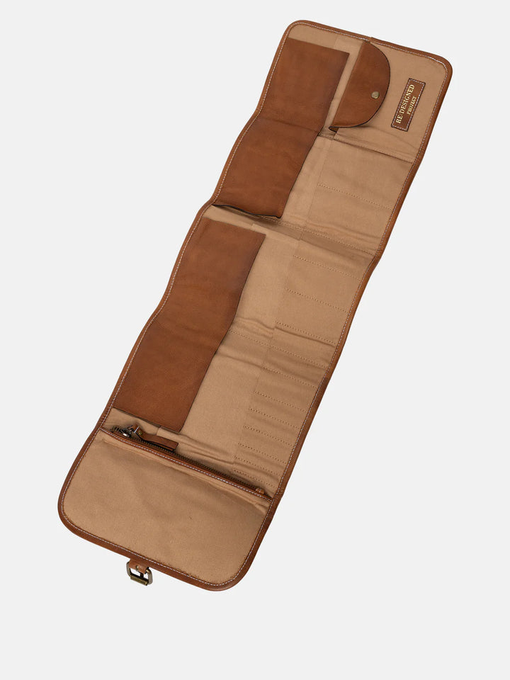 Brown leather needle organizer on a white background