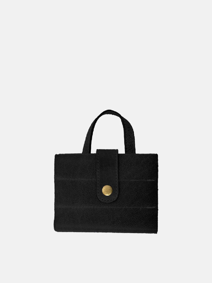 Black handbag with a gold button on a white background