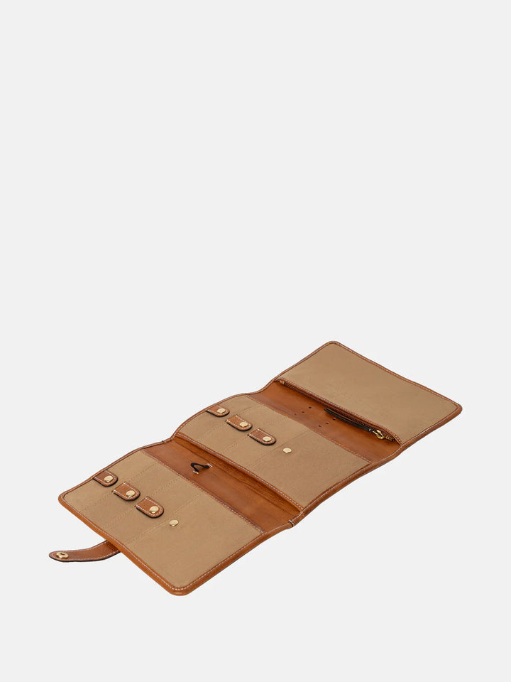 Open tan leather needle case on a white background