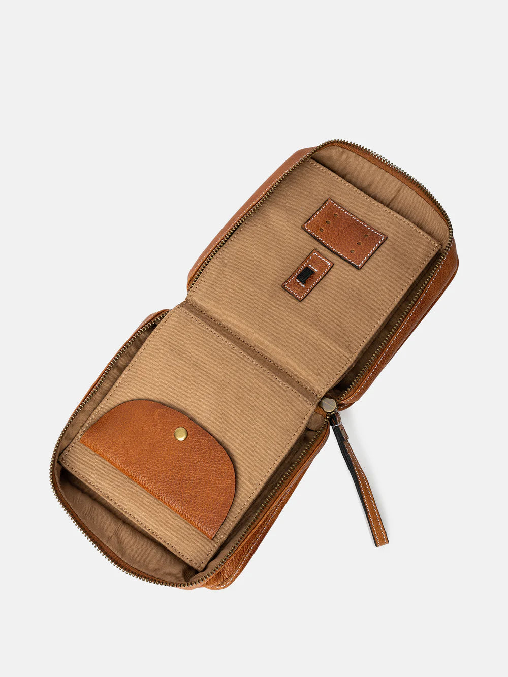 Open tan leather wallet with zipper on a light beige background