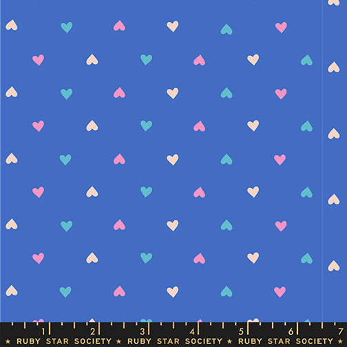 Pattern of colorful hearts on a blue background with a ruler at the bottom.