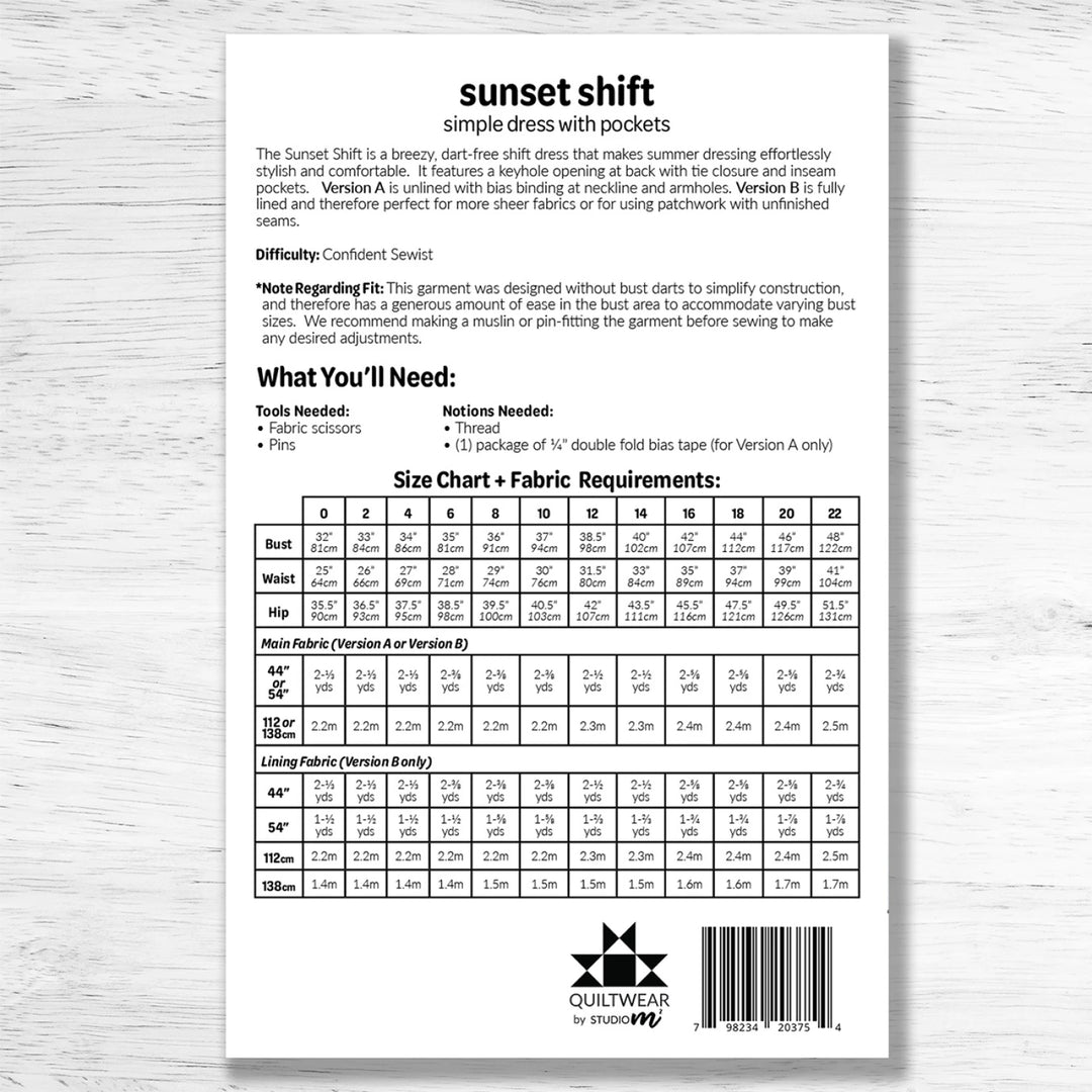 Pattern envelope with size chart and fabric requirements on a wooden surface