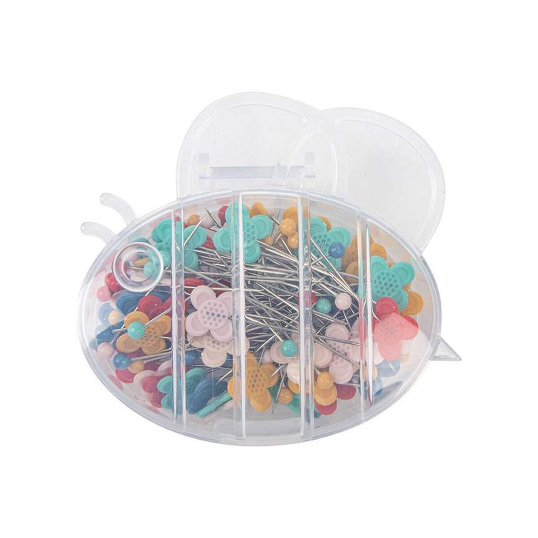 Clear container with colorful sewing pins on a white background