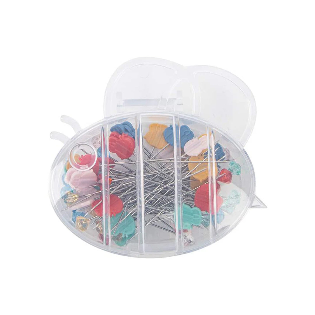 Clear container with colorful quilting pins on a white background