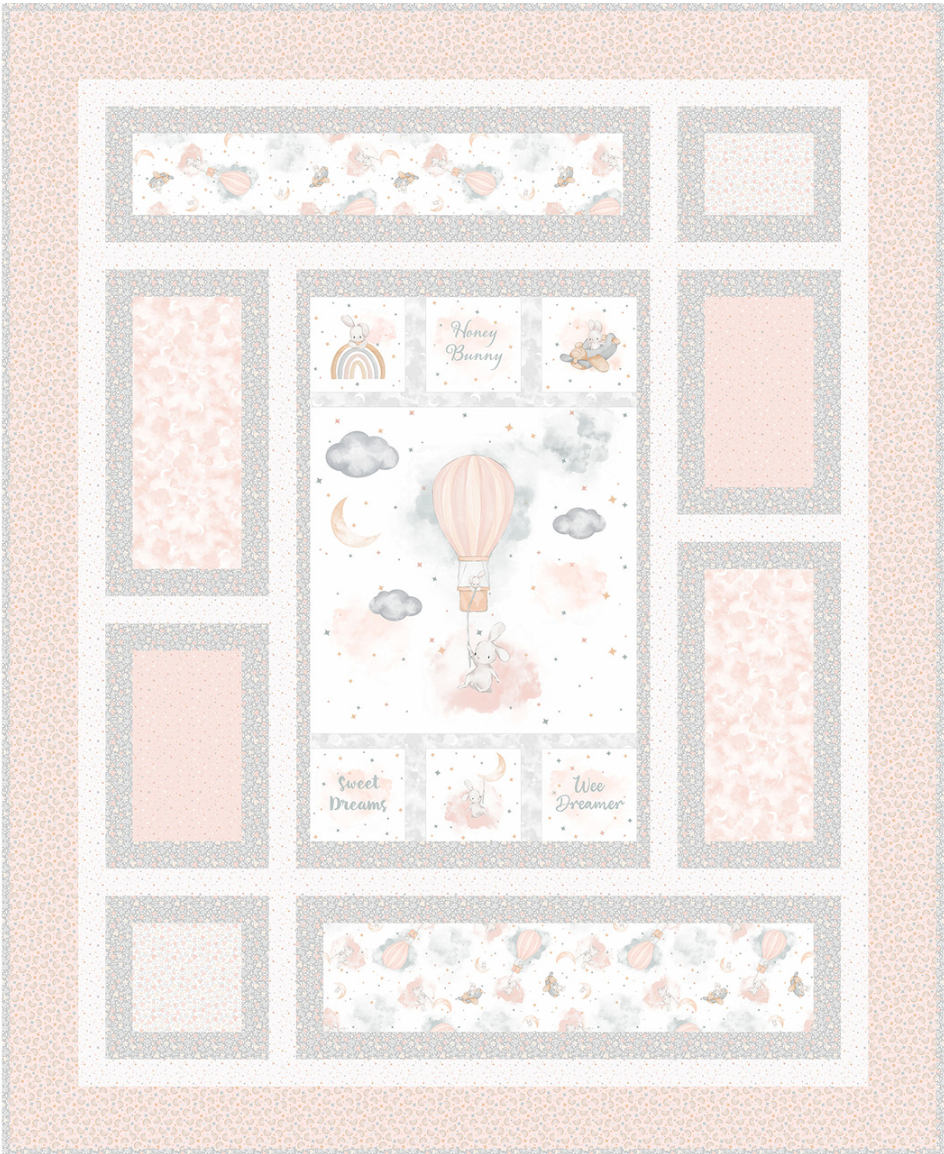 Baby quilt with various patterns and illustrations on a light pink background