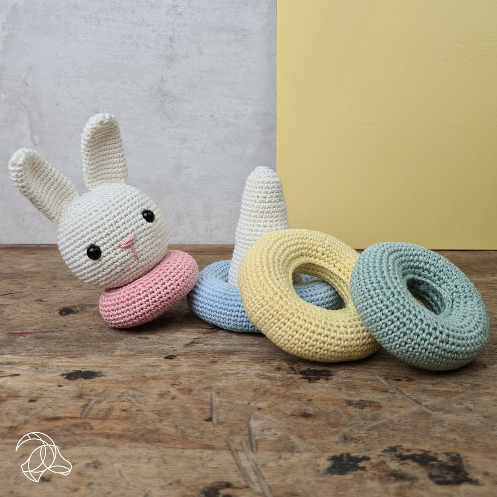 Crocheted Stacking Bunny sample shown on a wooden background