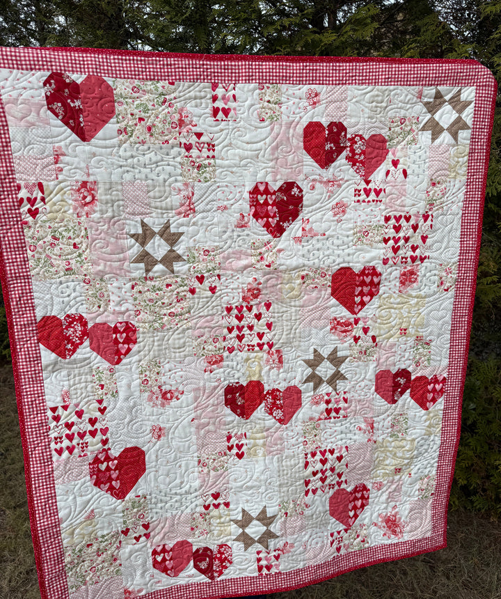 Quilt with red and beige patterns on a surface