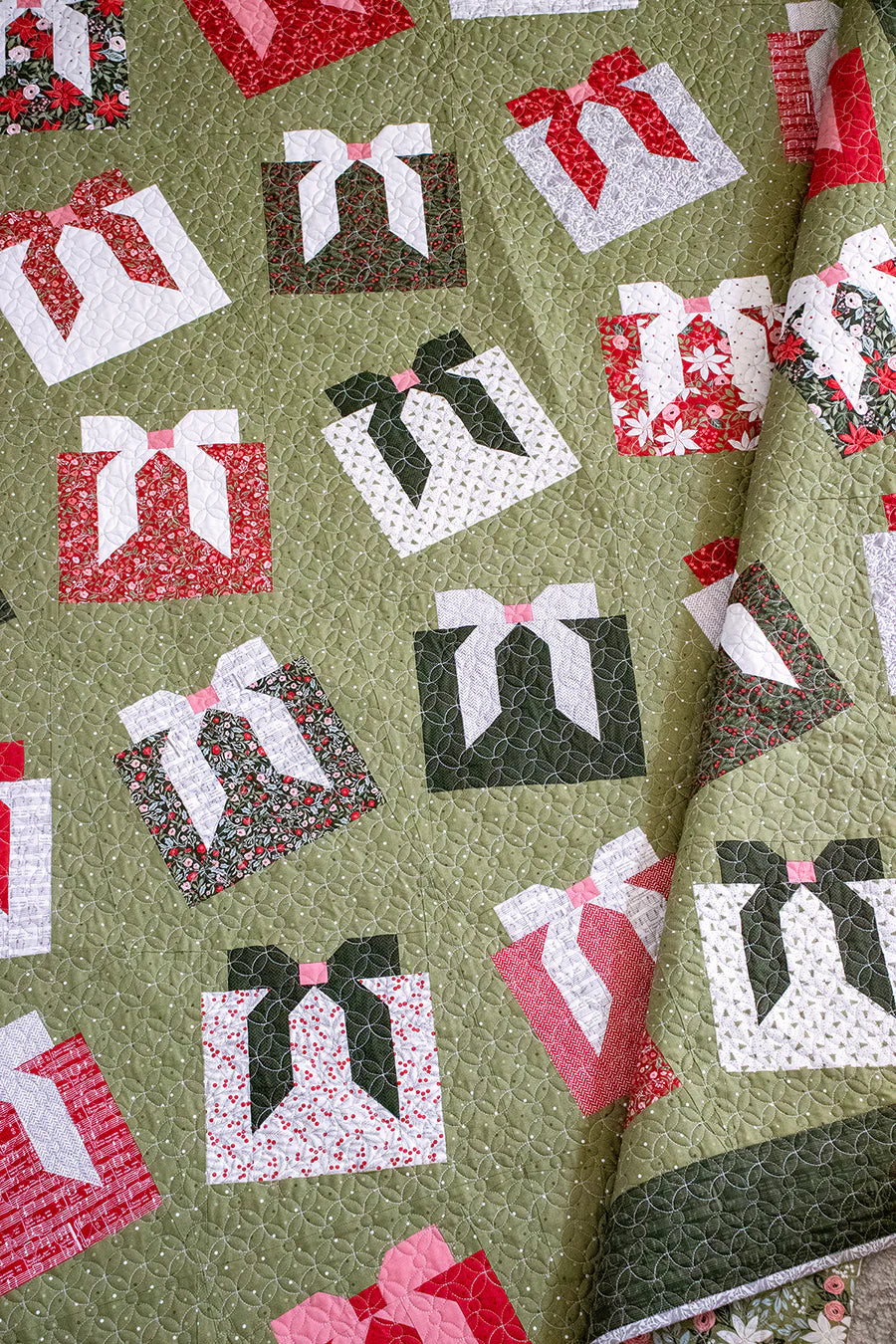 Pattern of gift boxes with ribbons on a green background