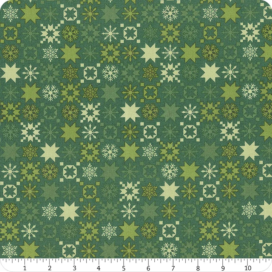 Green fabric with an assortment of multi colored green snowflakes