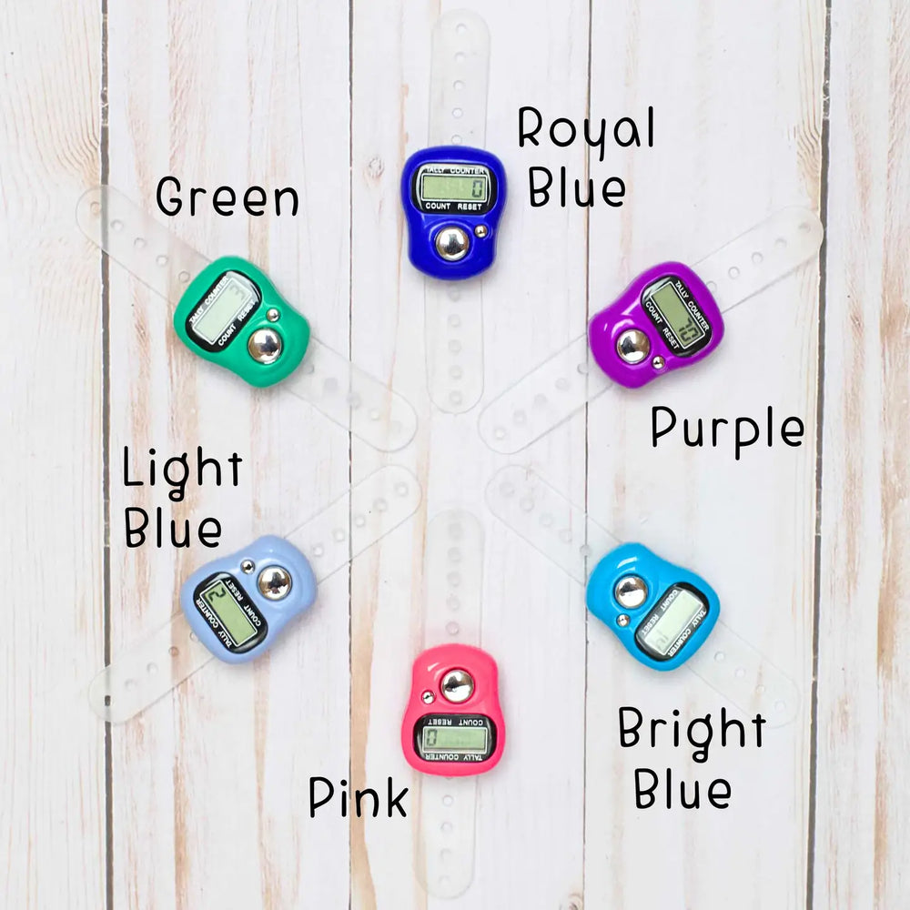 Colorful digital beepers on a wooden surface with labels for each color.