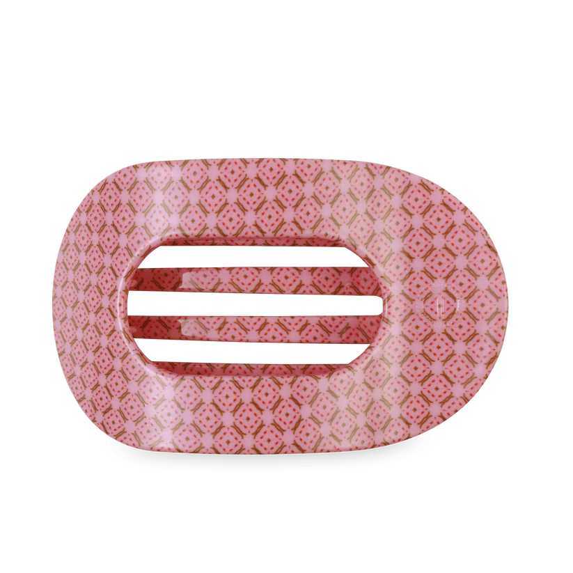 Pink hair clip with a geometric pattern on a white background