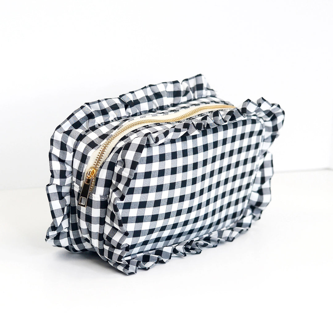 Black and white checkered pouch with ruffled edges on a white background