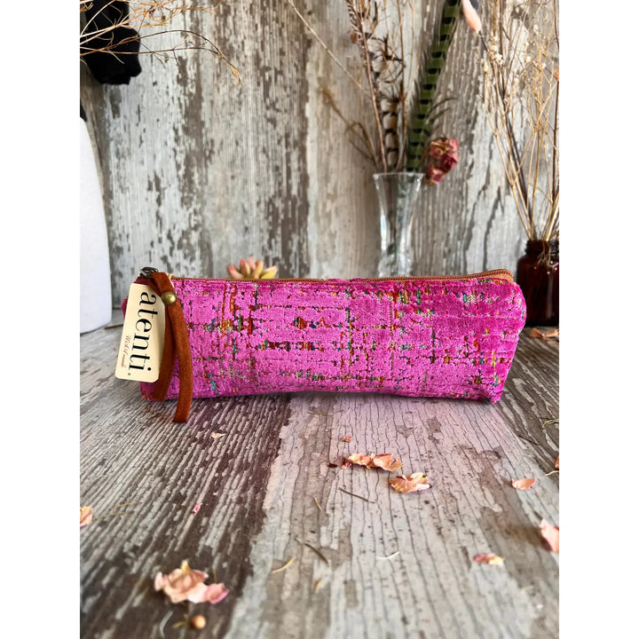 A pouch in pink distressed or textured cut velvet pattern.
