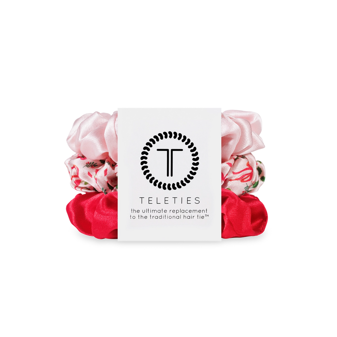 Pink and red scrunchies with a white card displaying 'Teleties' brand on a white background