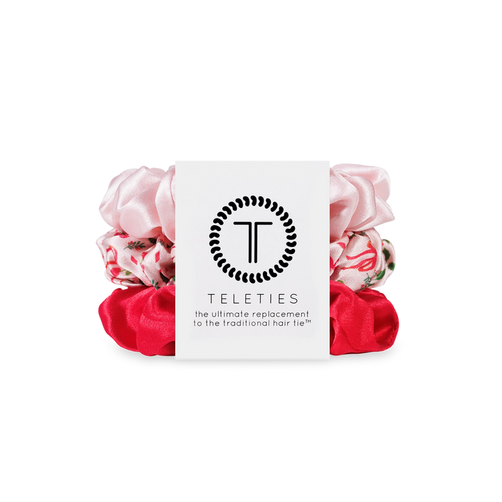 Pink and red scrunchies with a white card displaying 'Teleties' brand on a white background