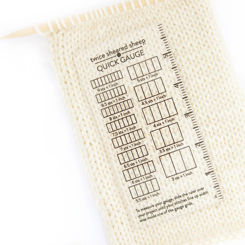 Knitting gauge swatch with printed measurement chart on a white background
