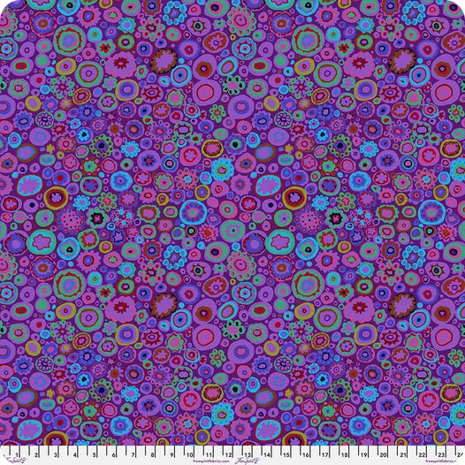 Colorful circular pattern fabric with a ruler at the bottom