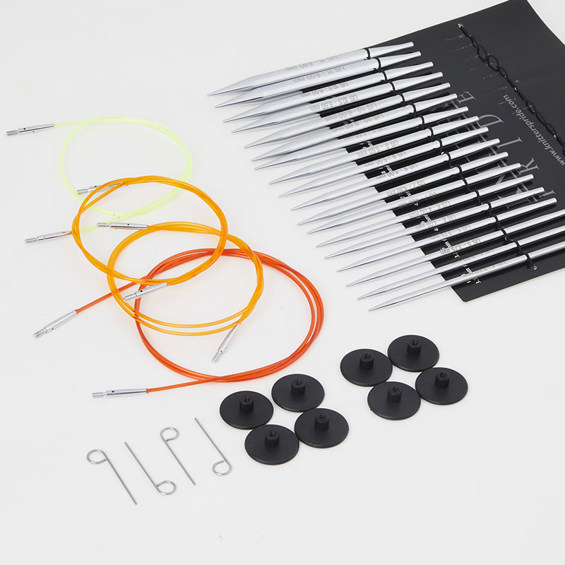 package showing contents: needles in storage position with cables laid to the side (yellow, orange and red), 8 black end stoppers, and 4 metal adjustment tools