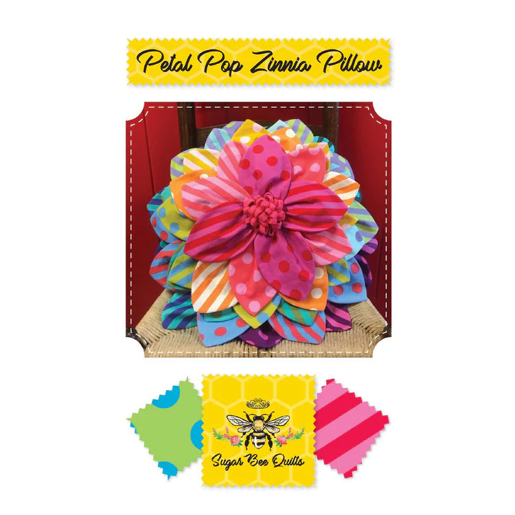 Colorful flower-shaped pillow with 'Sugar Bee Quilts' branding on a white background