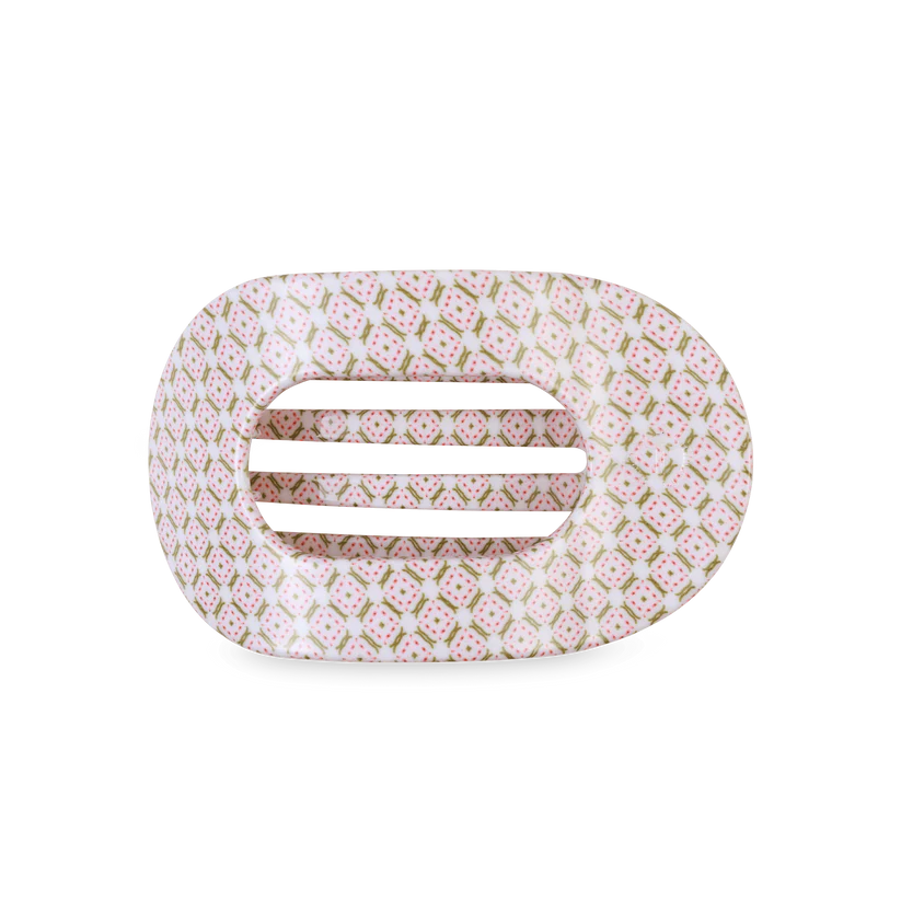 Decorative hair clip with pink and gold pattern on a white background