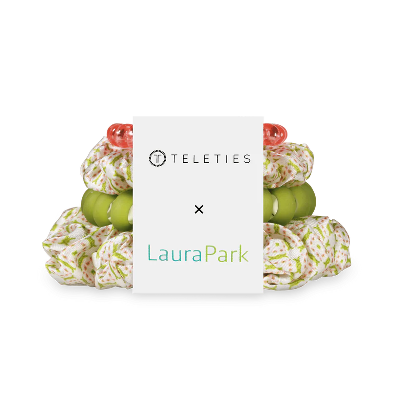 Hair ties with floral design and green centers on a white background, branded as Teleties Laura Park.