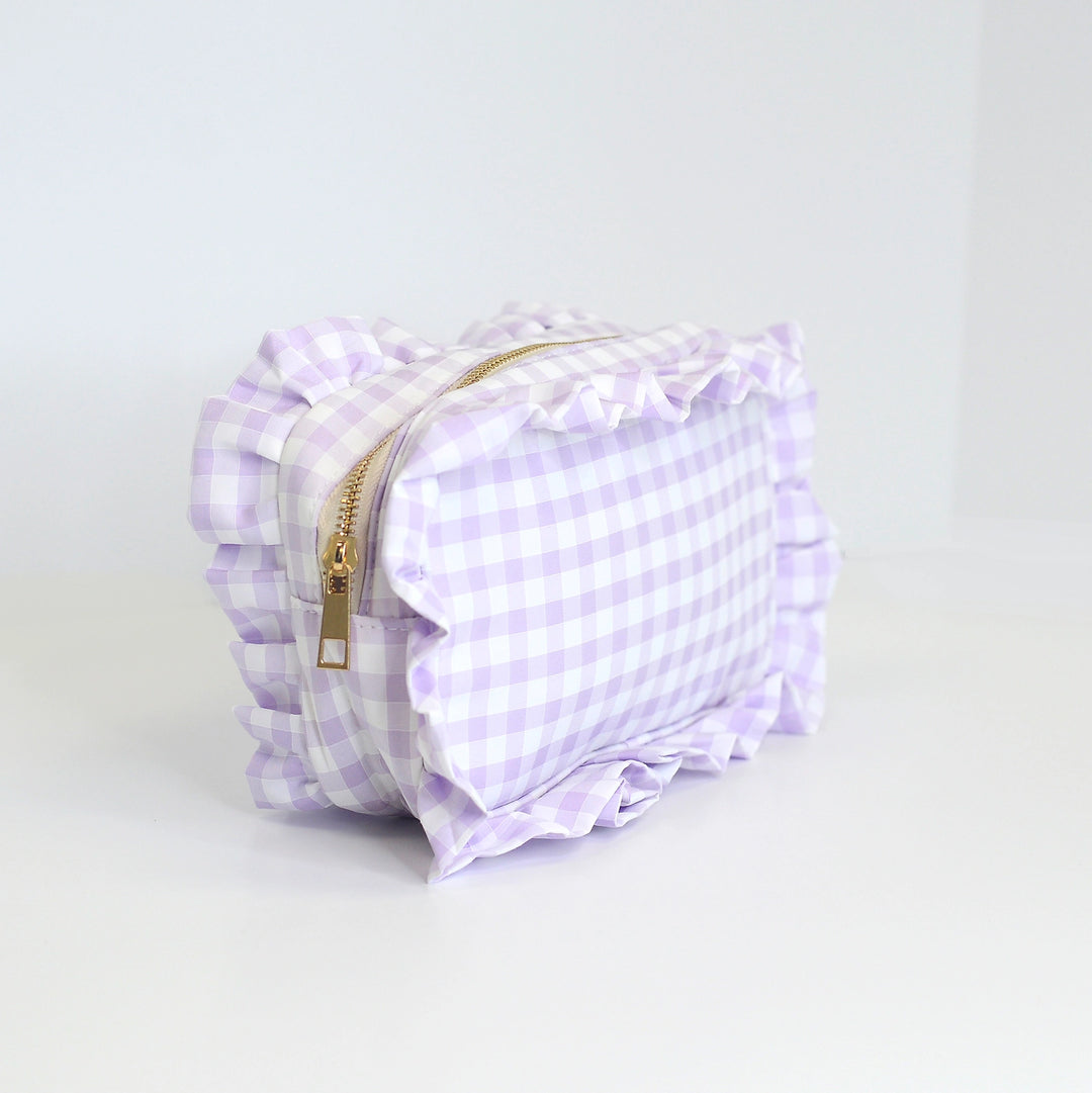 Purple checkered bag with a gold zipper on a light gray background