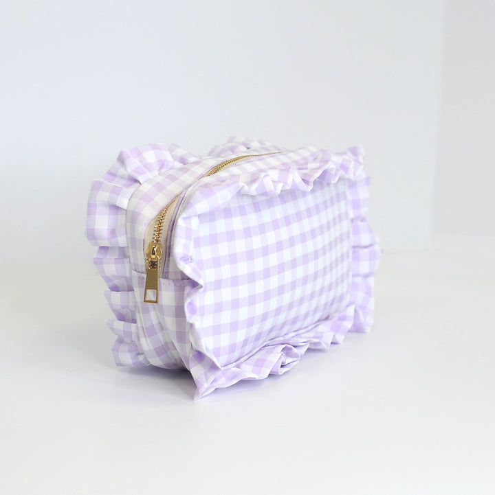 Purple checkered bag with a gold zipper on a light gray background