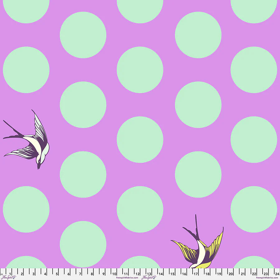 Fabric with bright purple background, large turquoise dots, and birds flying