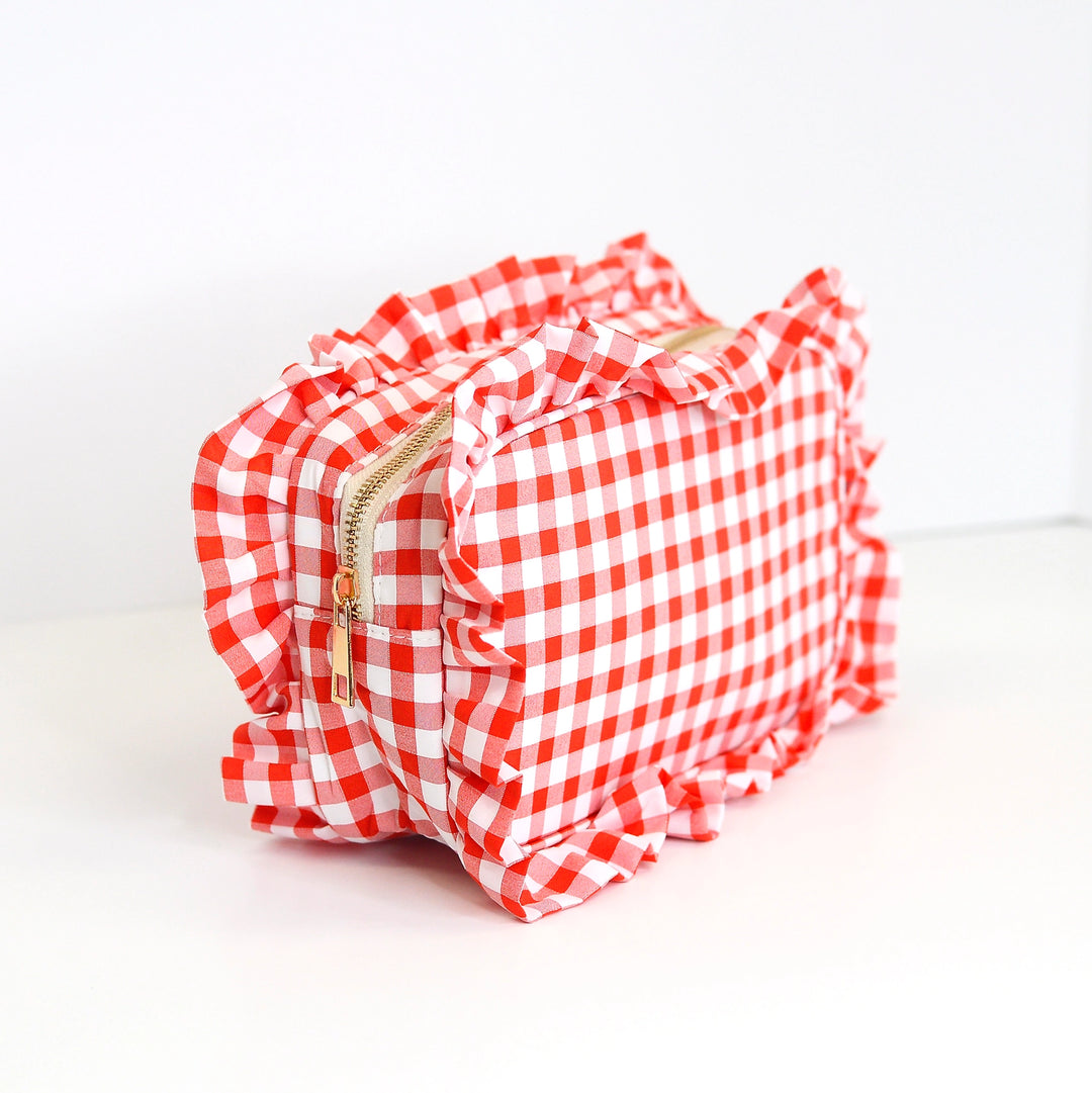 Red and white checkered pouch with ruffles on a white background