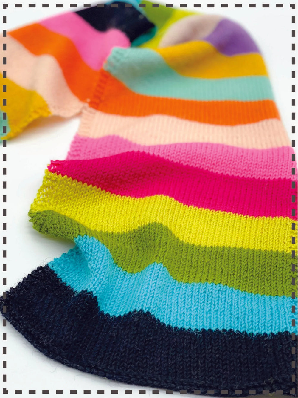 Colorful striped sock with a patterned border on a white background