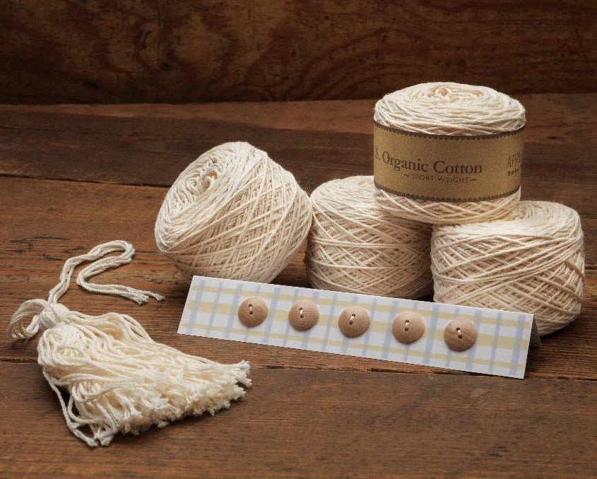 Contents of the Cardigan Tassel Knit Kit includes yarn, buttons, and tassel