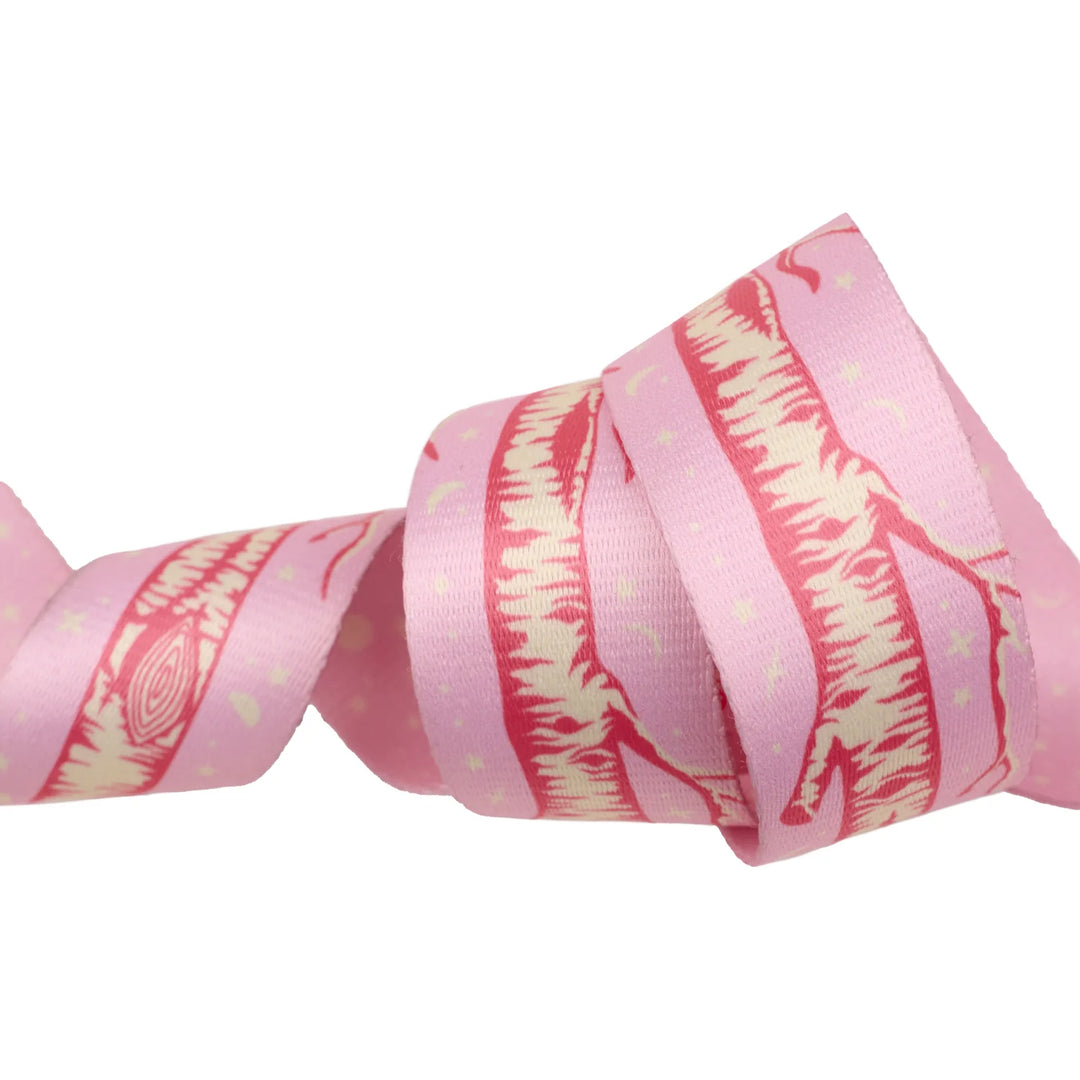 pink webbing with a white tree trunk running down the length